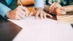 Pessoas assinando um contrato Built to Suit.